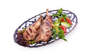 Meat on a grill with vegetables