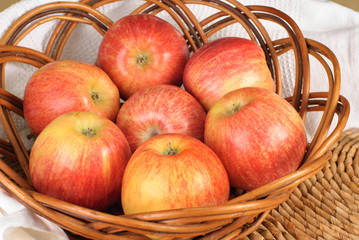 Red Gala apples in a wicker plate