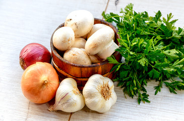 Fresh mushrooms champignon in wooden bowl