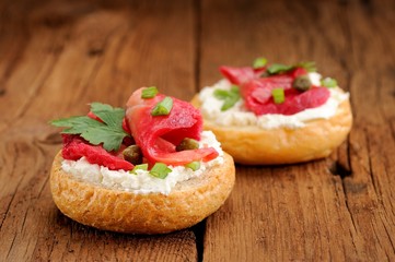 Two sandwiches with cured salmon, cream cheese, parsley, capers