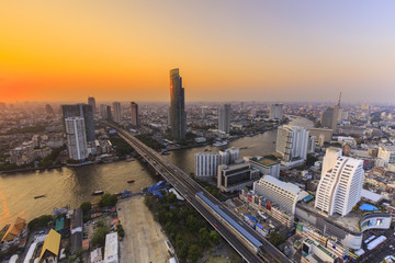 Naklejka na ściany i meble River in Bangkok city with high office building at sunset