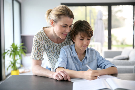 Mother Helping Kid With Homework