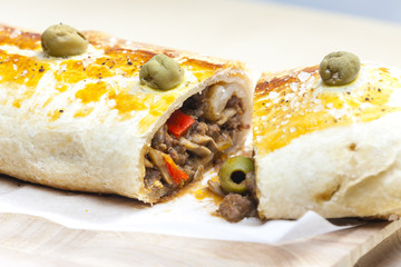 puff roly-poly filled with minced meat and green olives
