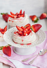 Pavlova meringue cake decorated with fresh strawberry