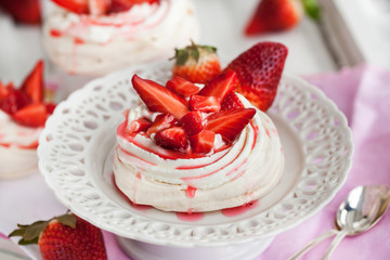 Pavlova meringue cake decorated with fresh strawberry