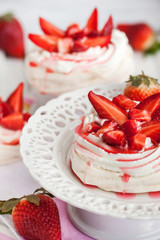 Pavlova meringue cake decorated with fresh strawberry