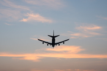 Silhouette of an airplane with sunset sky