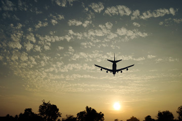 Silhouette of an airplane with sunset sky