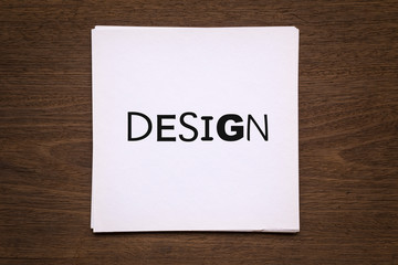 White paper cards with word " Design " on natural wood backgroun