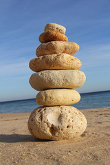 Fototapeta na wymiar pebble stack on sandy beach