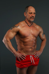 Fototapeta na wymiar Muscular middle age man showing his muscules