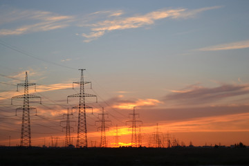 Electric power transmission lines at sunset.