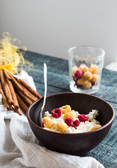 cottage cheese with raspberries in a dark clay plate, cinnamon s