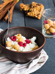 cottage cheese with raspberries in a dark clay plate, cinnamon s