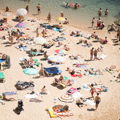 People and sun umbrellas on the beach