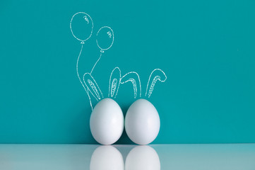 White eggs painted like rabbits on the blue background