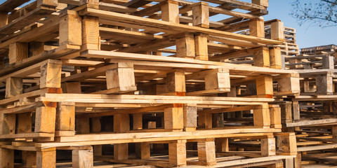 Wooden transport pallets in stacks. 