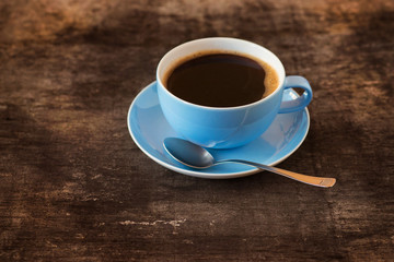 Cup of coffee on a wooden table background