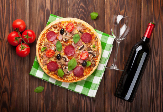 Italian pizza with pepperoni and red wine