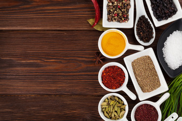 Various spices on wooden background