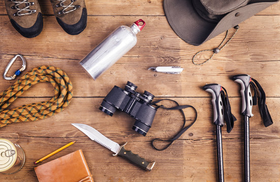 Equipment for hiking on a wooden floor background