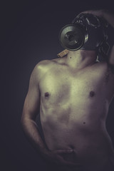 Fototapeta na wymiar concept of risk of contamination, naked man with gas mask