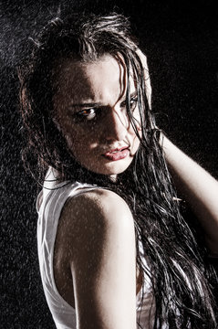 Wet sexy woman covered with water drops
