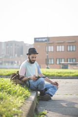 Fototapeta premium young handsome hipster gay modern man using tablet