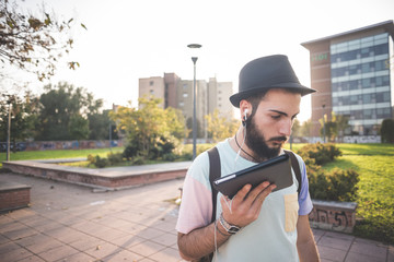 young handsome hipster gay modern man using tablet