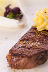Grilled beef steak topped with butter and rosemary