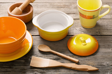 Different tableware on wooden background