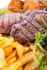 Platter of mixed meats, salad and French fries