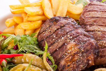 Platter of mixed meats, salad and French fries