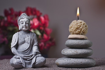 stones tower and candle, buddha