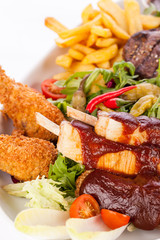 Platter of mixed meats, salad and French fries