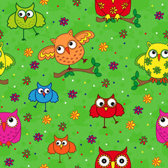 Seamless pattern with ornamental owls over green