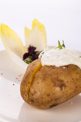 Baked jacket potato with sour cream sauce