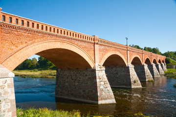 Fototapeta na wymiar Brick bridge across the Venta river