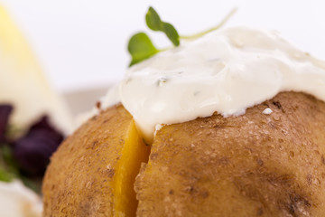 Baked jacket potato with sour cream sauce