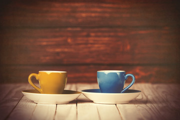 Two cups of coffee on wooden table