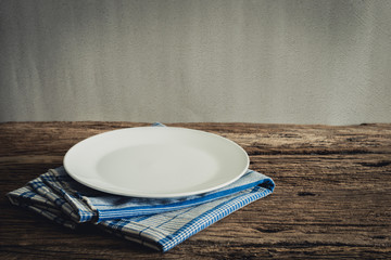 White Plate on a napkin. on wooden tabletop