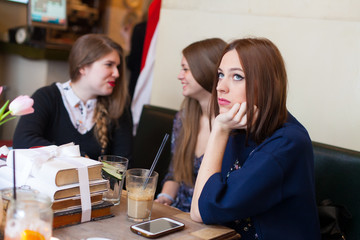 concerned young woman in coffee shop