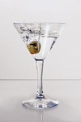 Martini glass with an olive
