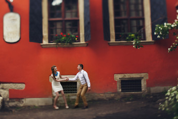 Fototapeta premium couple walk in old town lviv,kissing,loving. On the roof