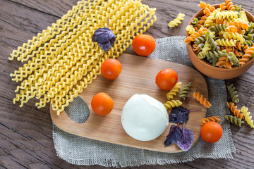 Various types of fusilli with ingredients