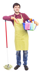 Full length portrait  of young man with apron holding cleaning e