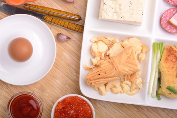 salami with pieces of cheese and egg