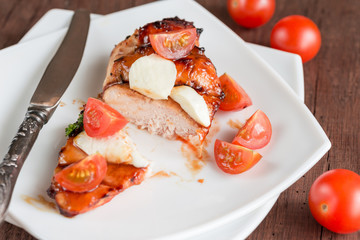 Grilled chicken steak with mozzarella and cherry tomatoes