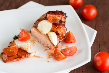 Grilled chicken steak with mozzarella and cherry tomatoes
