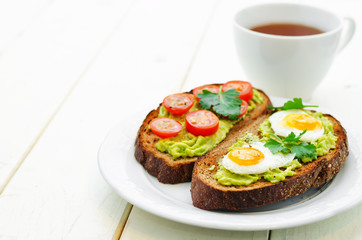 rye sandwiches and mashed avocado, eggs, tomatoes and cucumbers